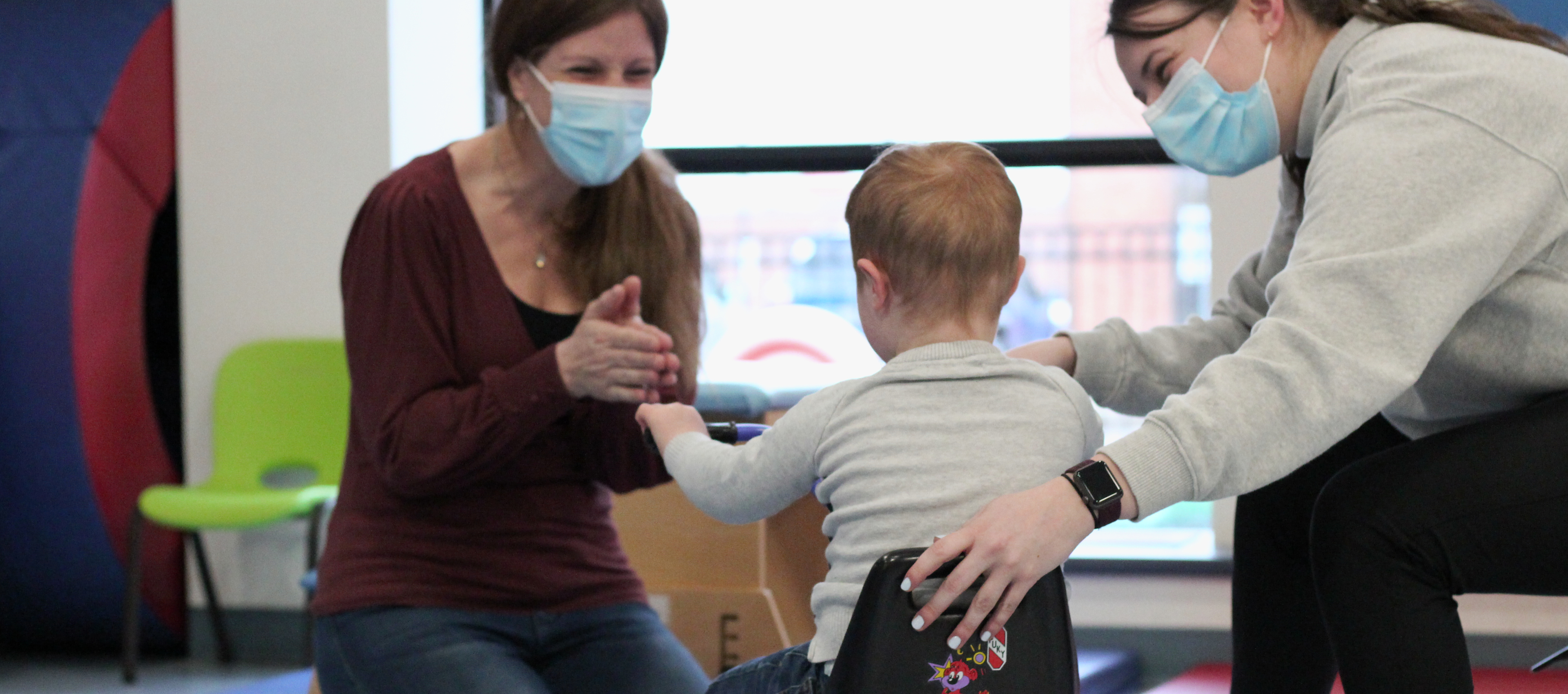 Occupational therapist works with child and mother to deliver therapeutic care to child at Niagara C